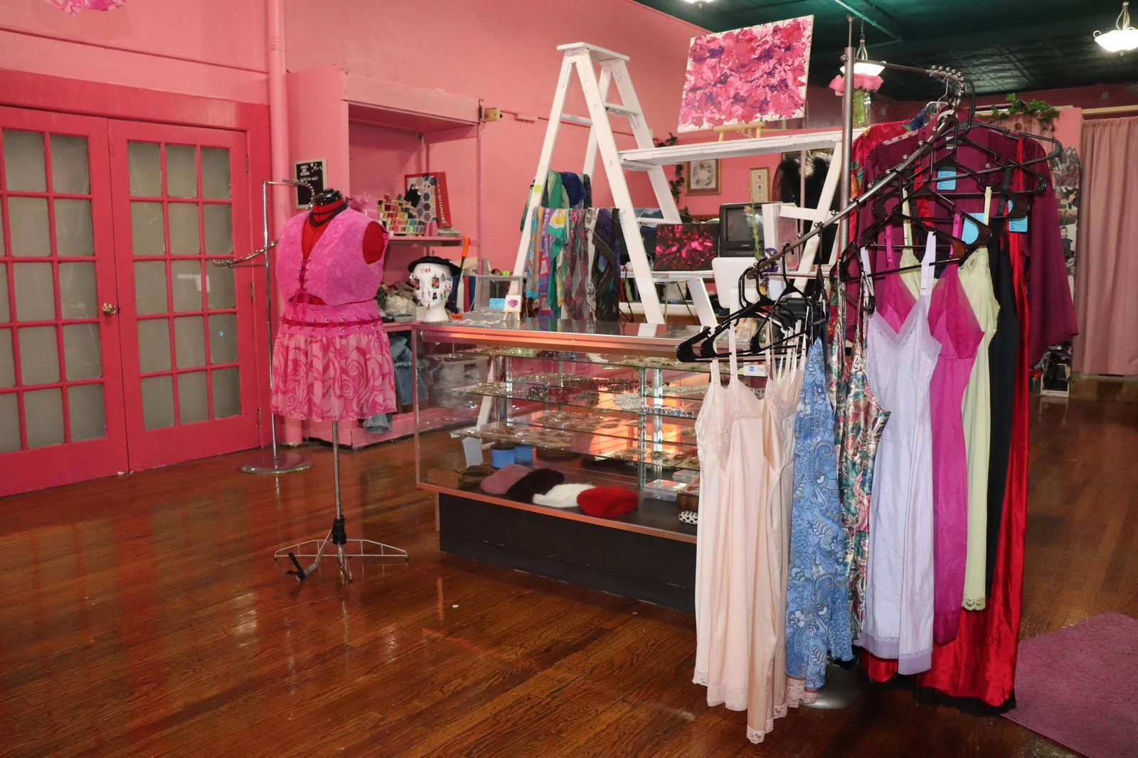 Inside the space: wood floors, display case and french doors